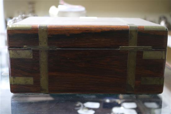 A Victorian brass mounted rosewood toilet box, containing four silver mounted bottles and four nail implements, box 28cm.